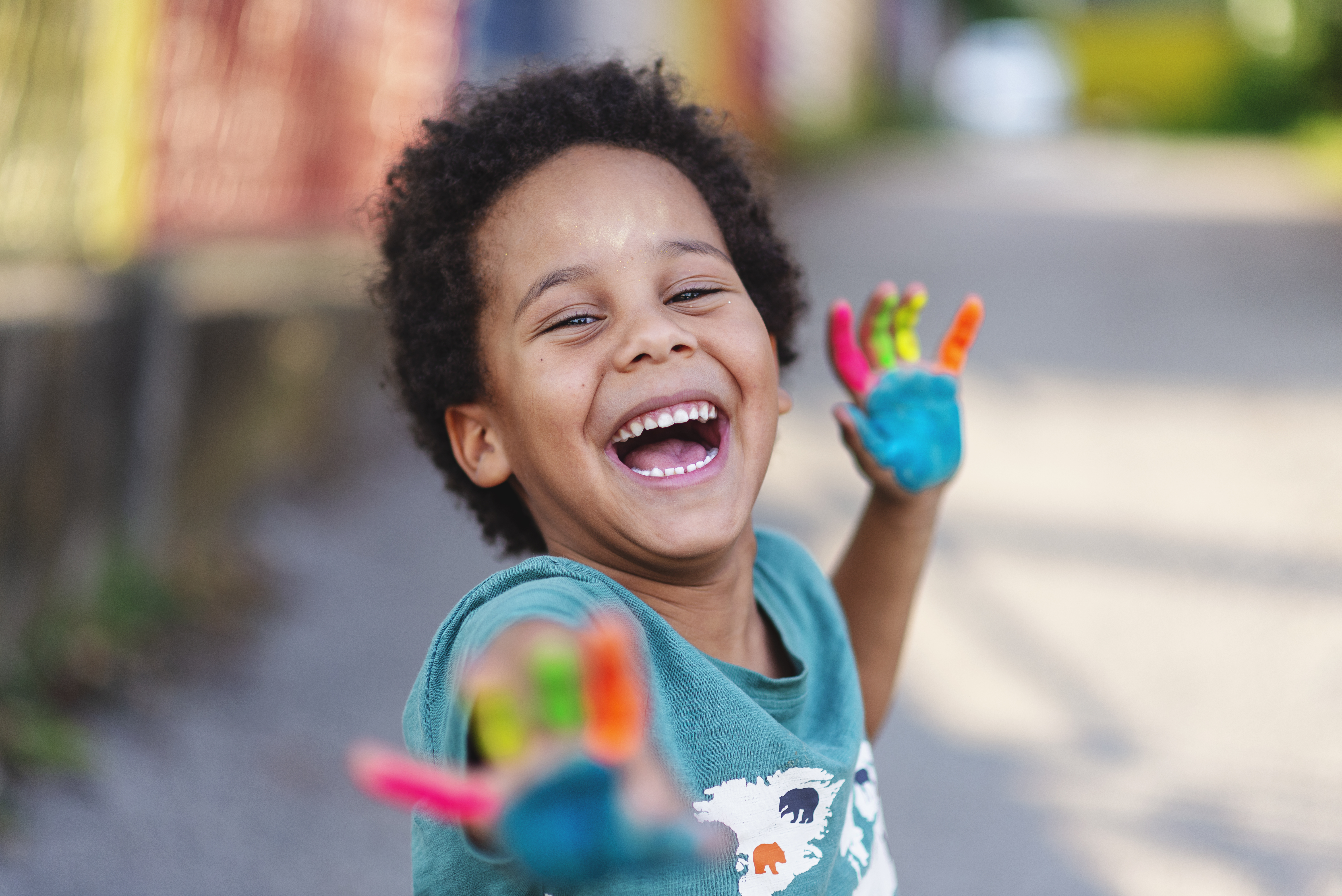 beautiful happy boy with painted hands, artistic, educational, fun concepts